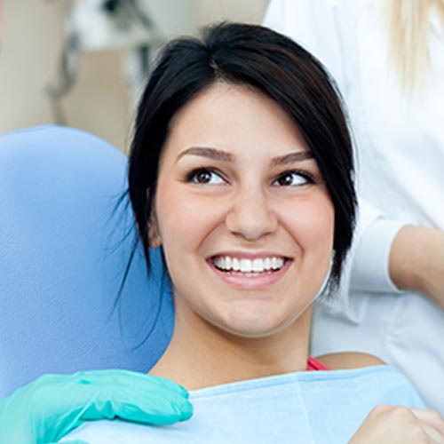 smiling woman during dental hygienist appointment, general dentistry in Mississauga