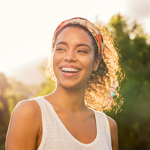 young women showing her perfect smile after gum grafting