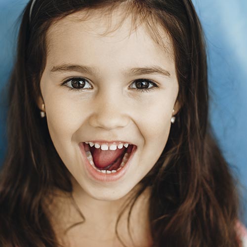 little girl smiling after getting dental sealants